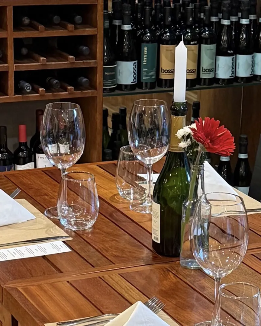 Prateleiras de vinhos e mesa posta na adega da Decanter